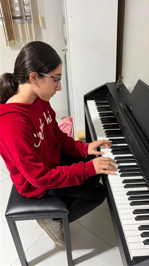 Adolescente tocando piano na Spasso Musical
